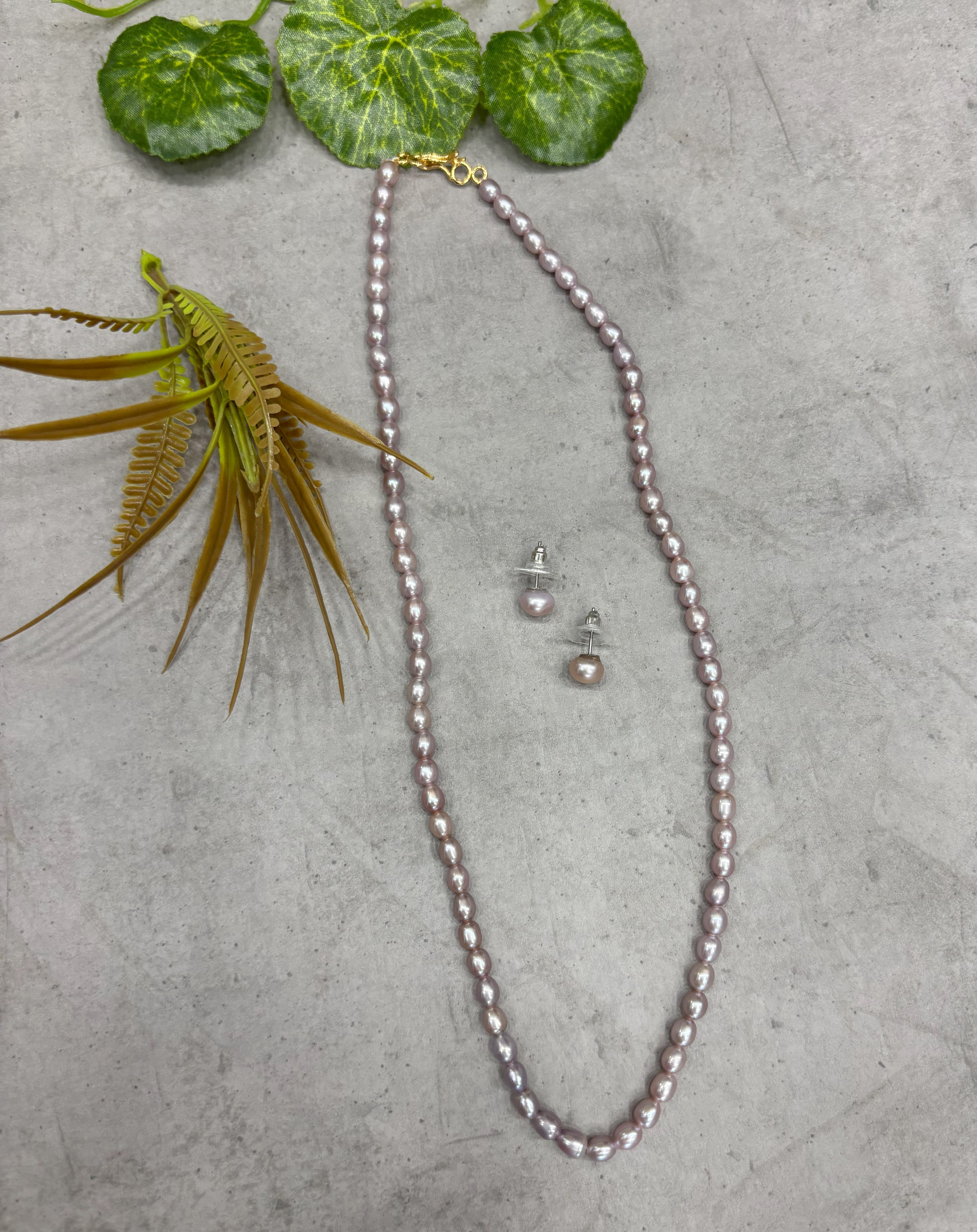 Buy Freshwater Pearl Mala necklace and earrings online – displayed on gray surface